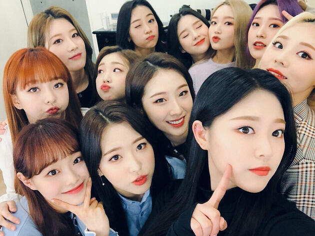 a group selfie of all twelve members of loona