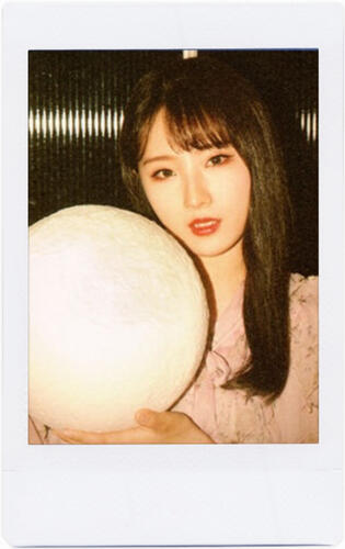 haseul carrying a moon-shaped light, from the orbit 1.0 photobook