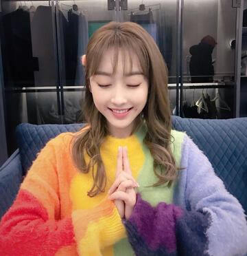 xuan lu in a rainbow sweater